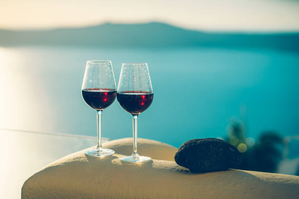 istock Wine glasses with red wine, Santorini island, Greece 1393761502