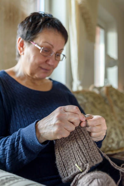 istock Mature woman knitting hat 1393761959