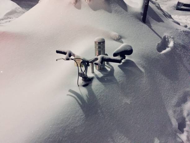 A bicycle covered by snow