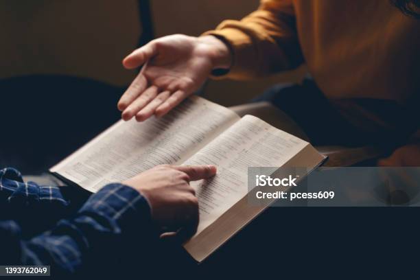 Male Reading The Holy Bible By Pointing To The Character And Sharing The Gospel With A Friend Holy Bible Study Reading Together In Sunday Schoolstudying The Word Of God With Friends Stock Photo - Download Image Now