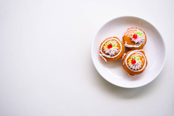 Thai Cake Traditional on plate.Kanom Kai. dessert snack original style Thai. Cake jam orange and cream homemade breakfast bakery. tasty and sweet food. hight sugar and hight fat. free space,flat lay.