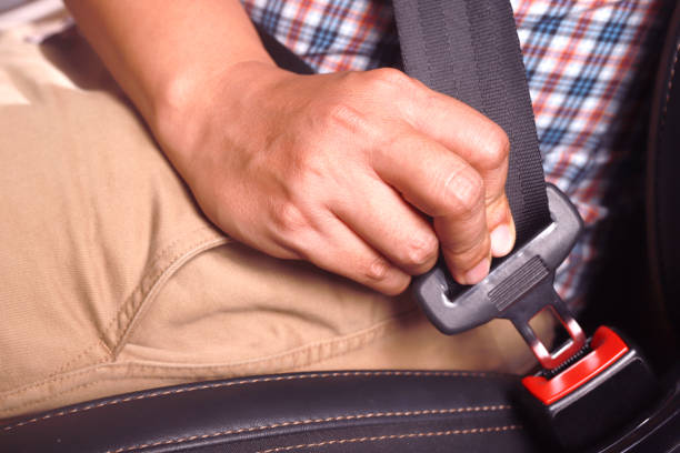 istock The driver wearing a seat belt Every time for safety road. 1393763659