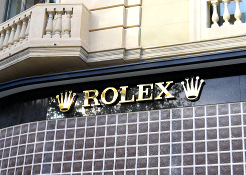 Rolex logo on the facade of a watch shop. December 15, 2021, Spain, Catalonia, Barcelona.
