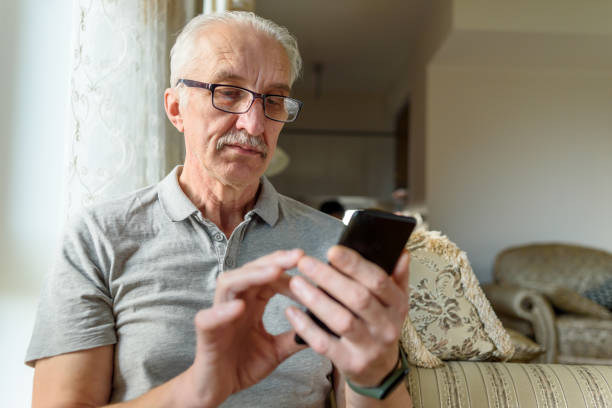 istock Senior man in eyeglasses using mobile phone 1393764817