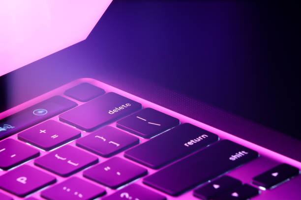 istock beautiful purple light laptop/keyboard 1393765105