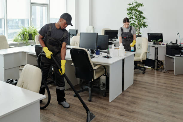 istock Workers of cleaning service company carrying out their work in openspace office 1393767075