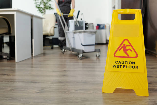 istock Caution of wet floor on yellow signboard in openspace office against cleaner 1393767096