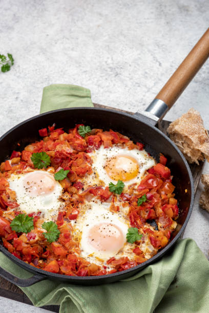 istock Shakshouka, eggs poached in sauce of tomatoes, 1393767603