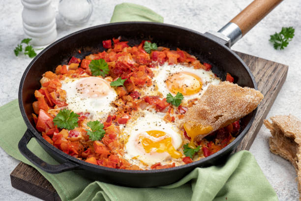 istock Shakshouka, eggs poached in sauce of tomatoes, 1393767604