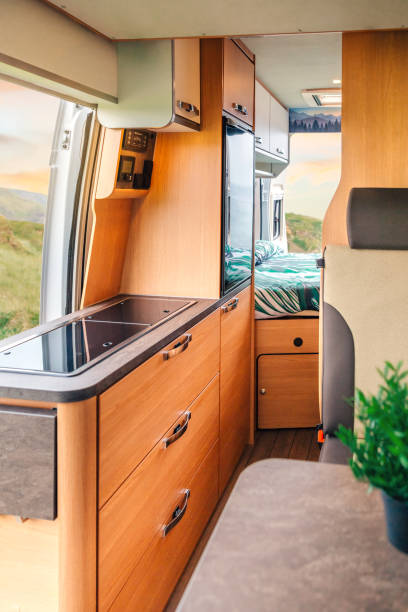 istock Interior of a camper van with kitchen and bed 1393768570