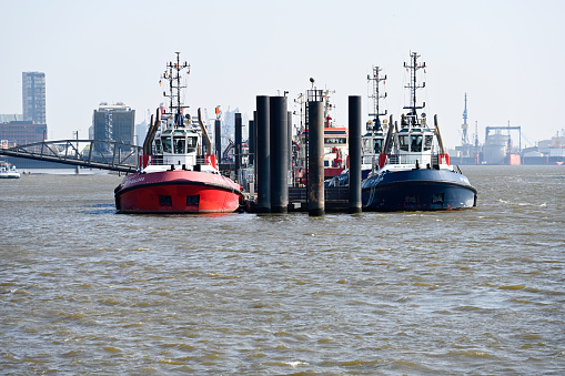 Hamburg, Germany, March 20, 2022 - Front view of a group of tugboats in the port of Hamburg