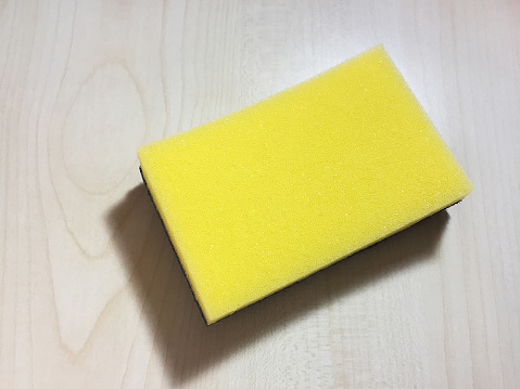 Directly above cleaning sponge on the wood background