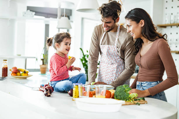 istock Young happy family making lunch in the kitchen. 1393770766