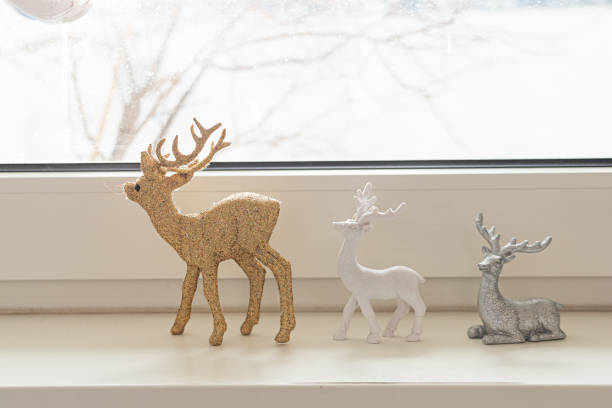 Cute Christmas reindeer on shimmering glitter, shiny stars and defocused lights in a yellow blue contrast.