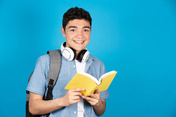 istock Portrait of hispanic student holding book 1393771301
