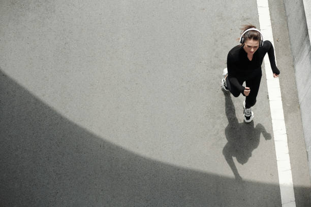 istock Sportswoman Jogging on Road 1393771353