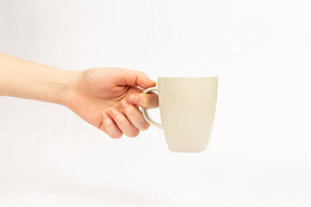 istock coffee cup in woman hand on white background 1393772327
