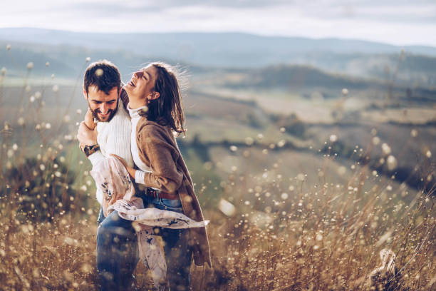 istock Young cheerful couple embracing with great affection during autumn day on a hill. 1393772410