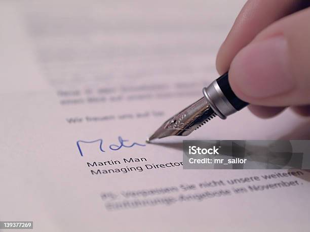 Hand Writing Their Signature On A Legal Document Stock Photo - Download Image Now - Agreement, Authority, Business