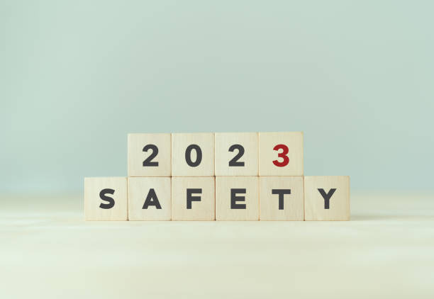 istock Work safety in 2023. Safety first, caution work hazards, danger surveillance, zero accident concept. Work safety planning and compliance. Wooden cubes inscripted 2023 and safety on smart background. 1393772823