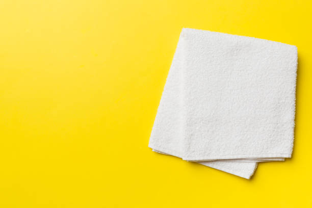 istock Top view of white towels with copy space on colored background 1393775412