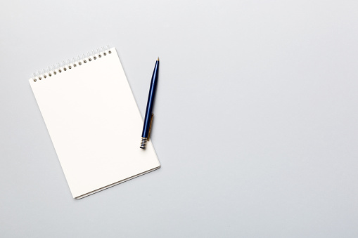 Blank notebook with pen on white background. Back to school and education concept.