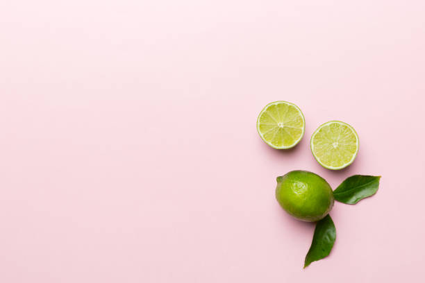 istock Lime fruits with green leaf and cut in half slice isolated on white background. Top view. Flat lay with copy space 1393775471