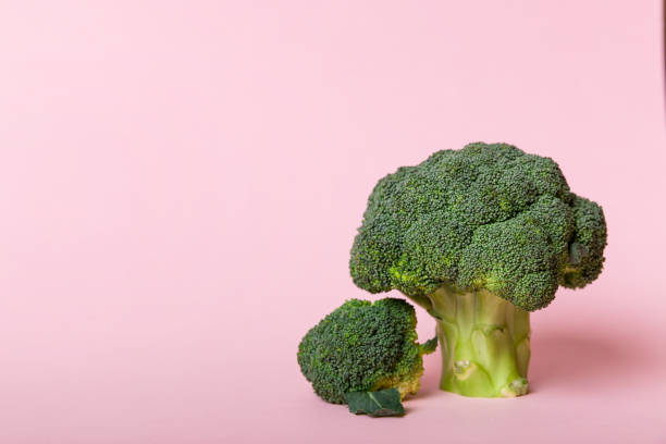 istock Top view fresh green broccoli vegetable on Colored background. Broccoli cabbage head Healthy or vegetarian food concept. Flat lay. Copy space 1393775513