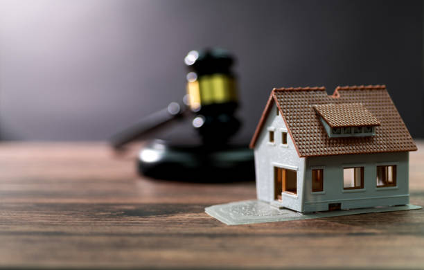istock Gavel and model house on the table 1393775856