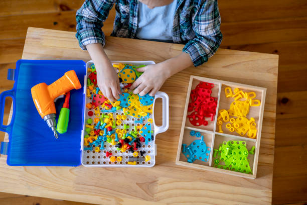 istock Happy little boy collects from the robot constructor. Montessori material. Home education. 1393776365