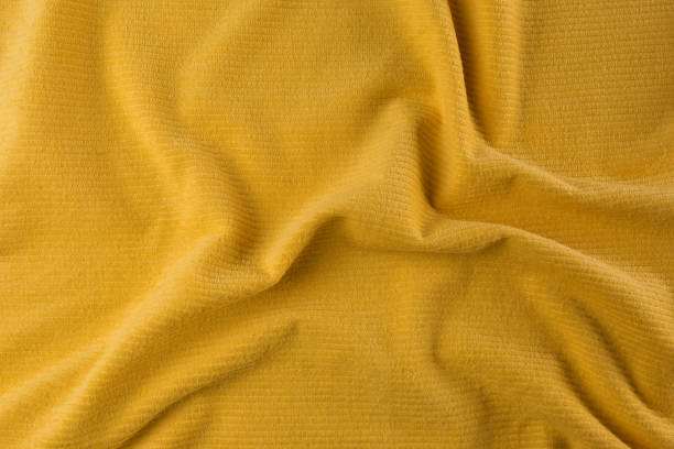 istock Crumpled yellow beach towel as background, top view 1393776561