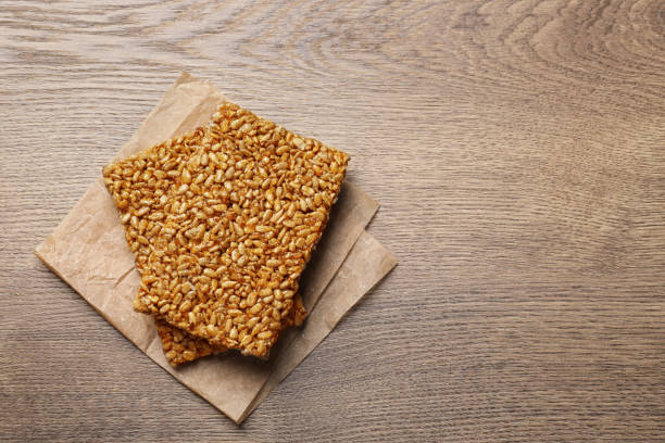 istock Delicious kozinaki bars on wooden table, top view Space for text 1393776610