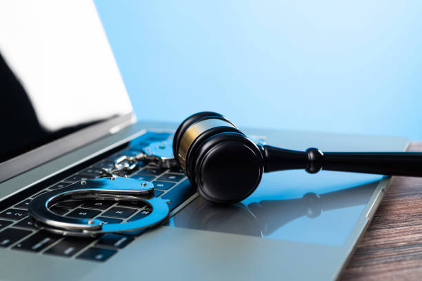 istock Gavel and handcuffs on laptop keyboard 1393776815