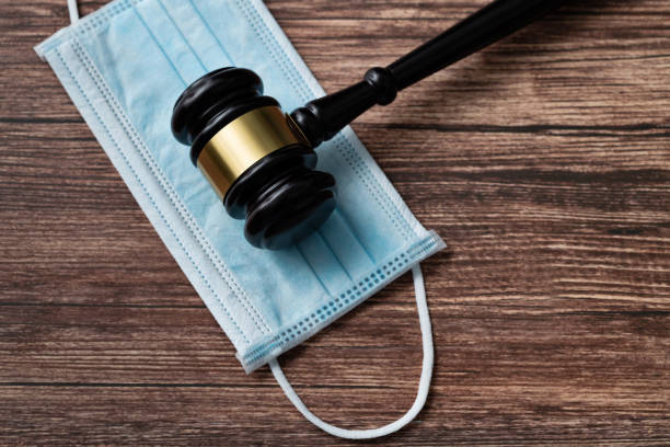 istock Gavel and protective face mask on the table 1393776866