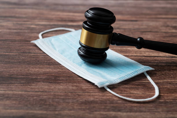 istock Gavel and protective face mask on the table 1393776869