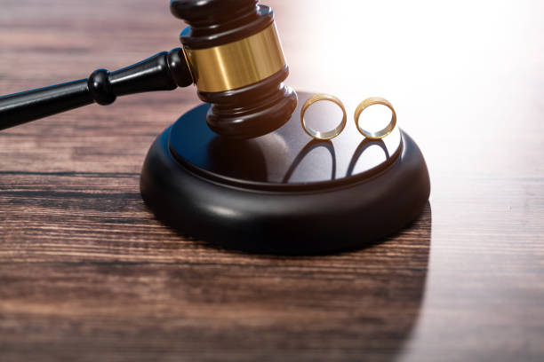 istock Wedding rings and gavel on wooden table 1393776897