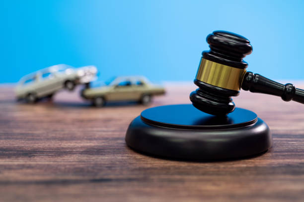 Gavel and model car on the table stock photo