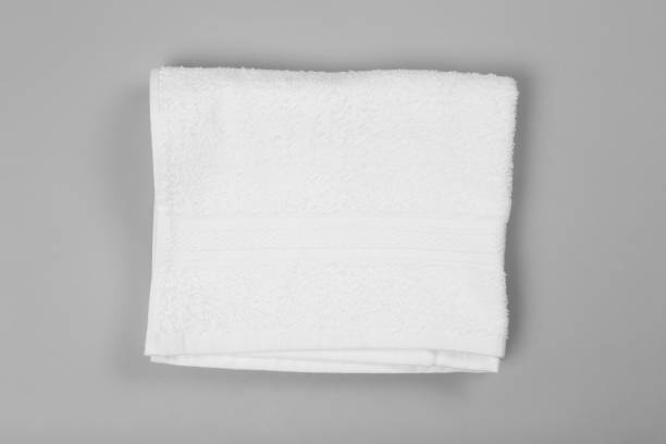 istock Folded white beach towel on light grey background, top view 1393777918