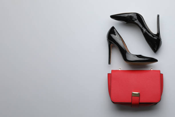istock Stylish woman's bag and shoes on light background, flat lay 1393778529