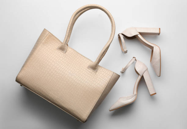 istock Stylish woman's bag and shoes on light background, flat lay 1393778561