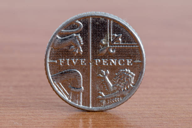 istock UK five pence coin on wooden table. 1393778996