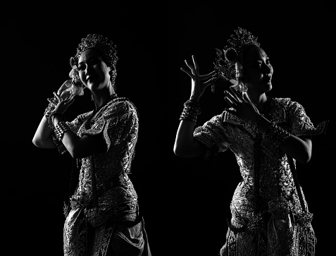 Half body of Asian Woman wear Thai Traditional Costume Dancer dress silhouette shadow. Khon dance is Act Play Royal of Thailand, Studio lighting over black background