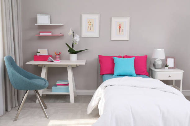 istock Modern teenager's room interior with comfortable bed and workplace 1393780404