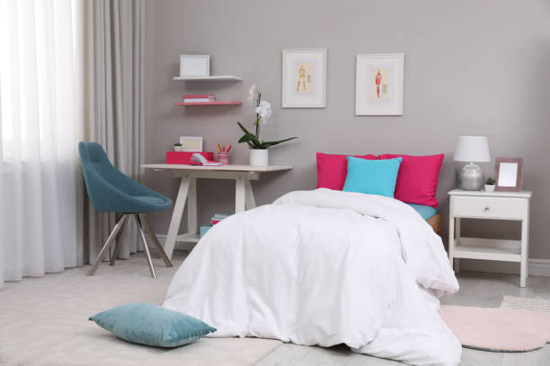 istock Modern teenager's room interior with comfortable bed and workplace 1393780436