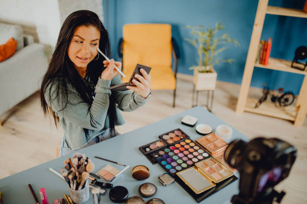 istock High-angle view of a young woman recording online make up video tutorial 1393781869