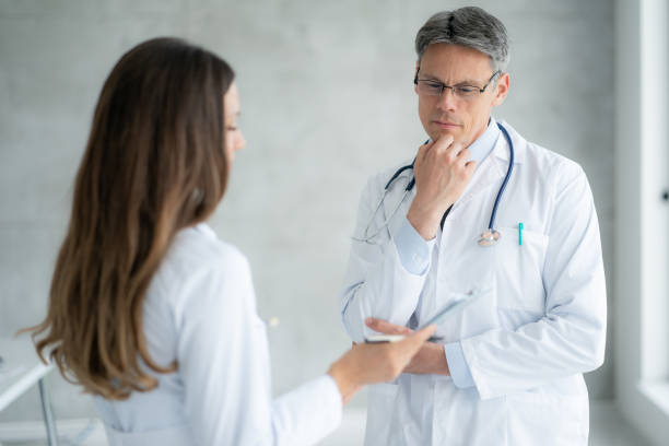 istock Two healthcare workers talking at hospital 1393782077