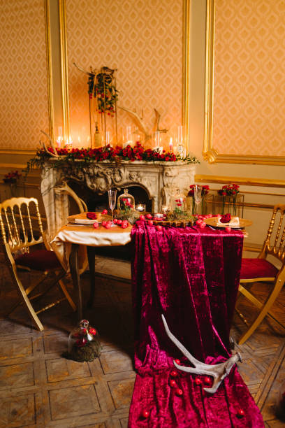 istock Floral compositions and candles on decorated dining table by the fireplace. 1393782221