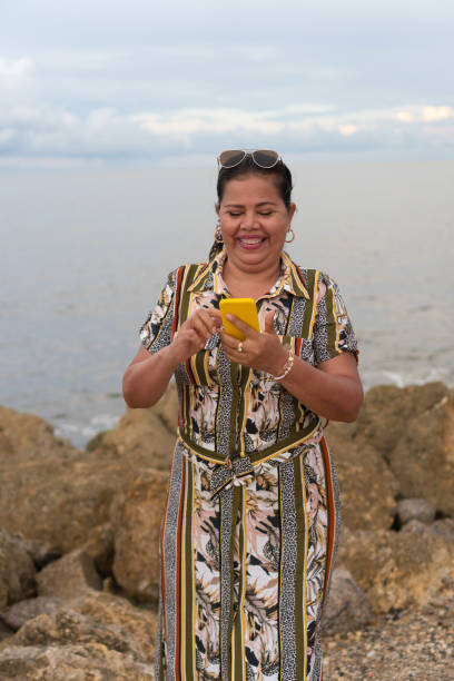 istock Senior Woman Looking At Her Cellphone 1393783198