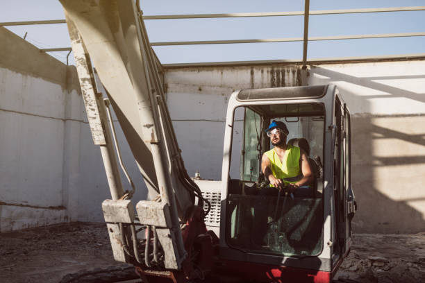 Man working with backhoe in construction site stock photo