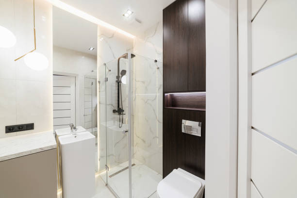 istock bright bathroom interior with glass shower mirror and lighting 1393783915